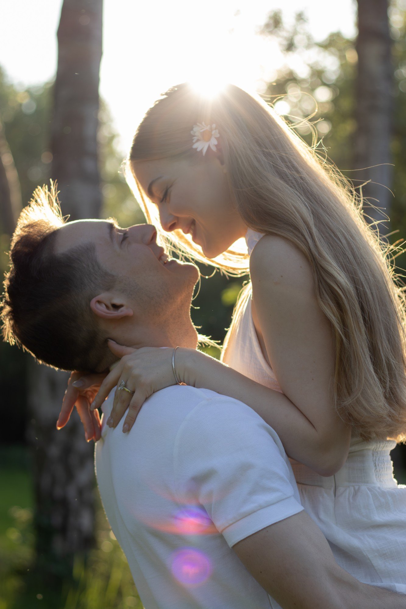 Yana and Guillaume laughing in golden light